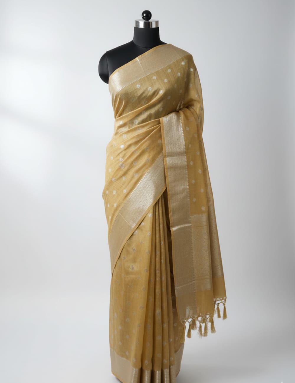 “Elegant Cream Tassar Silk Saree with Golden Woven Motifs and Tassel Border”