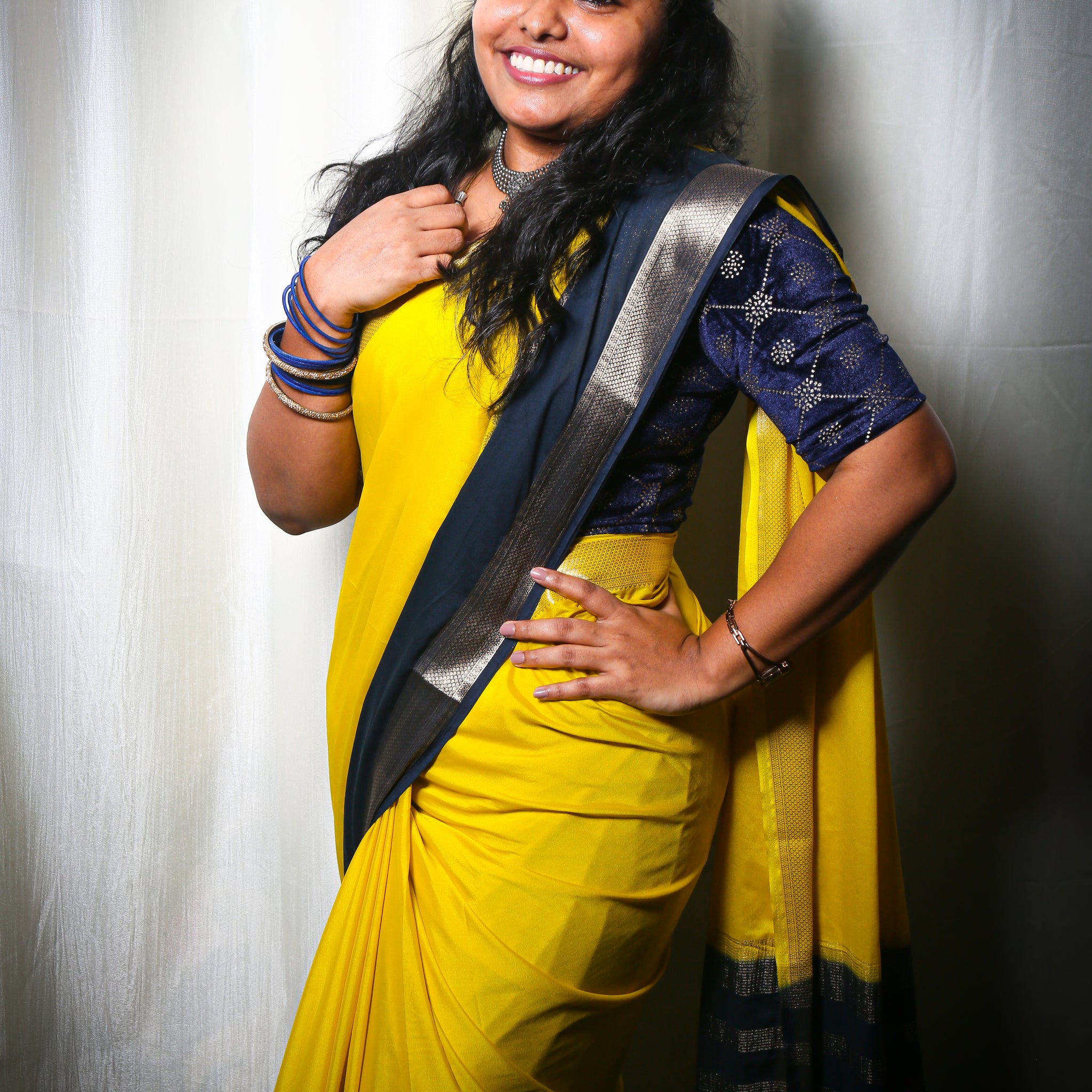 LEMON YELLOW AND NAVY BLUE CREPE SILK SAREE WITH A GOLDEN ZARI BORDER