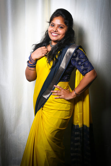 LEMON YELLOW AND NAVY BLUE CREPE SILK SAREE WITH A GOLDEN ZARI BORDER