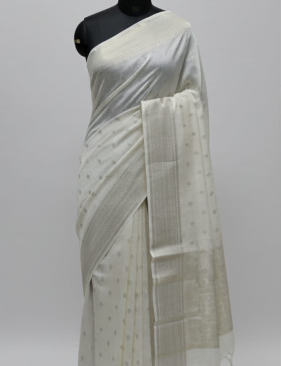 “Elegant Cream Tassar Silk Saree with Golden Woven Motifs and Tassel Border”