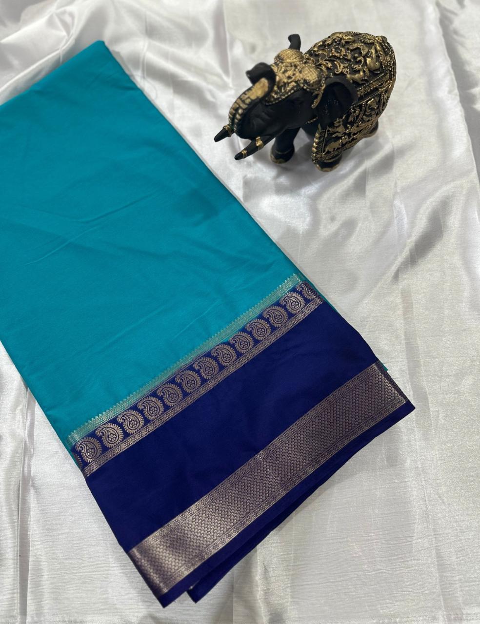 “Teal Crepe Silk Saree with Elegant Dark Navy Blue Border”