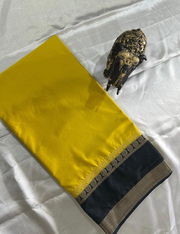 LEMON YELLOW AND NAVY BLUE CREPE SILK SAREE WITH A GOLDEN ZARI BORDER