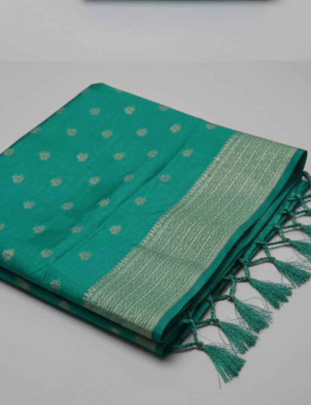 “Elegant Cream Tassar Silk Saree with Golden Woven Motifs and Tassel Border”