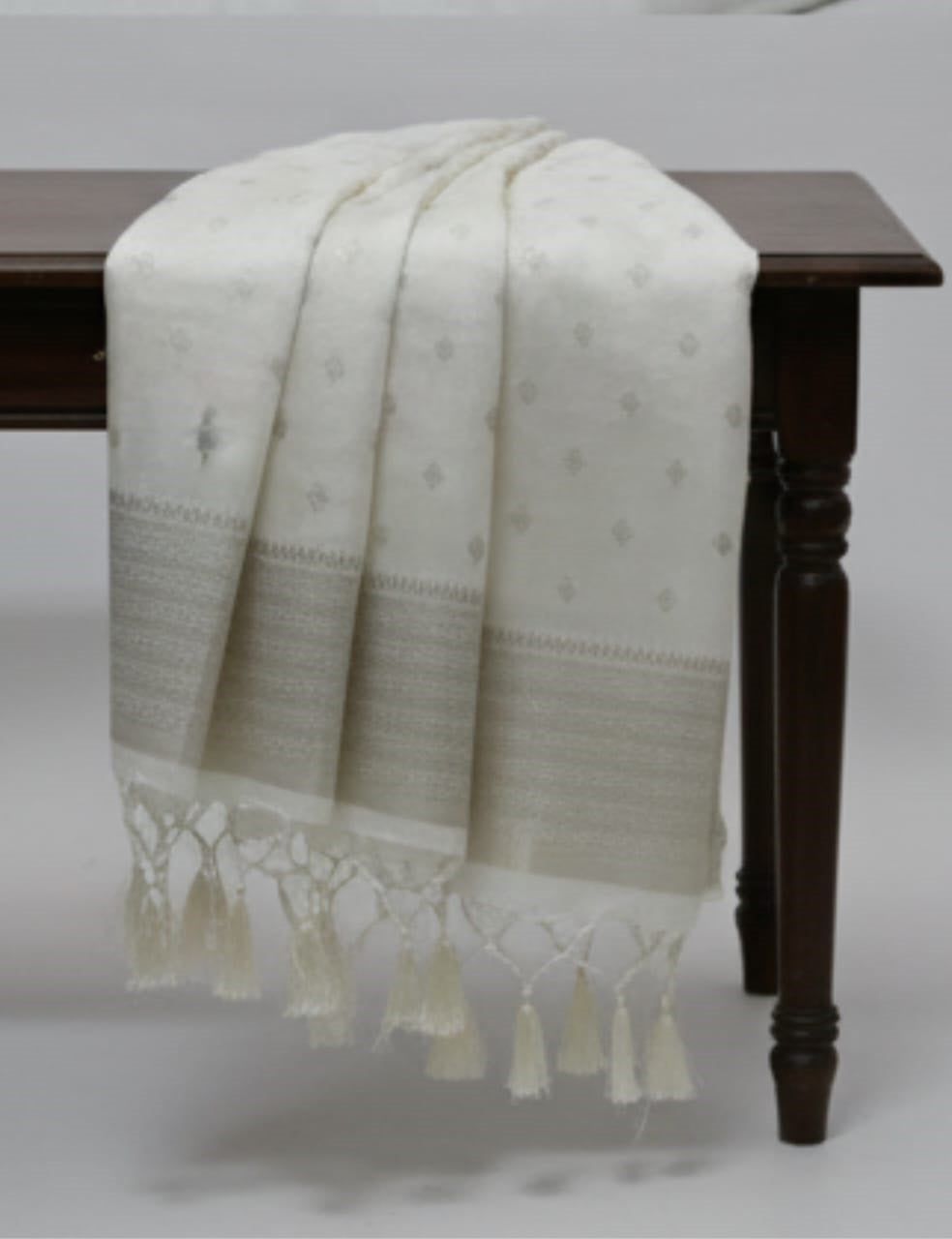 “Elegant Cream Tassar Silk Saree with Golden Woven Motifs and Tassel Border”