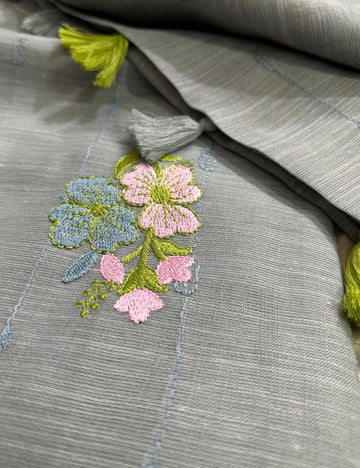 “Elegant Gray Handloom Saree with Floral Embroidery & Tassel Charm ”